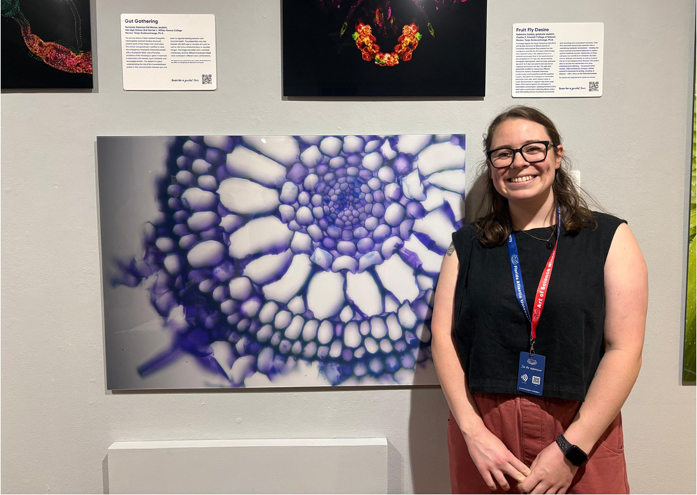 Alex Hoey poses with her honorable mention submission depicting the microscopic airspace tissues that supply seagrass roots with oxygen.