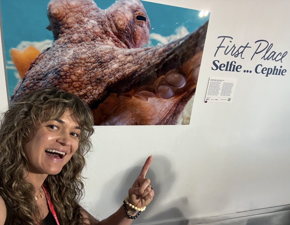 It’s selfie of selfie as first-place photographer, scientist, and science communicator extraordinaire, Dr. Chelsea Bennice, snaps her own photo with her first-place submission: “Selfie…Cephie” – a play on the group of animals octopuses belong to, cephalopods.
